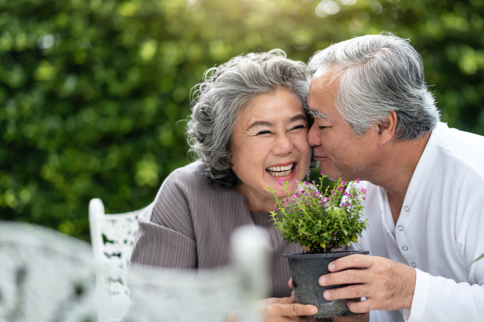 Happy older couple outside in garden