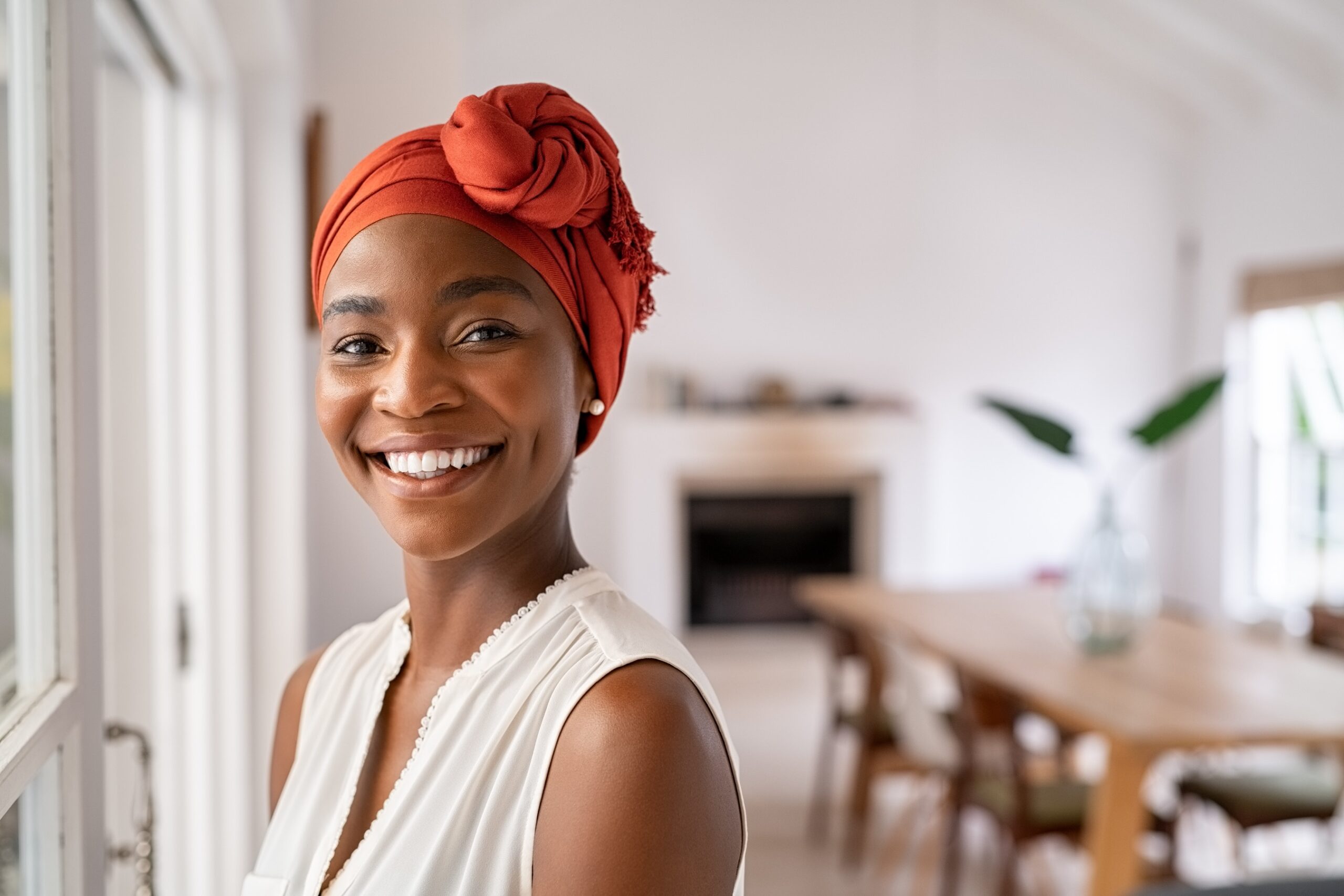 woman smiling while looking at camera.