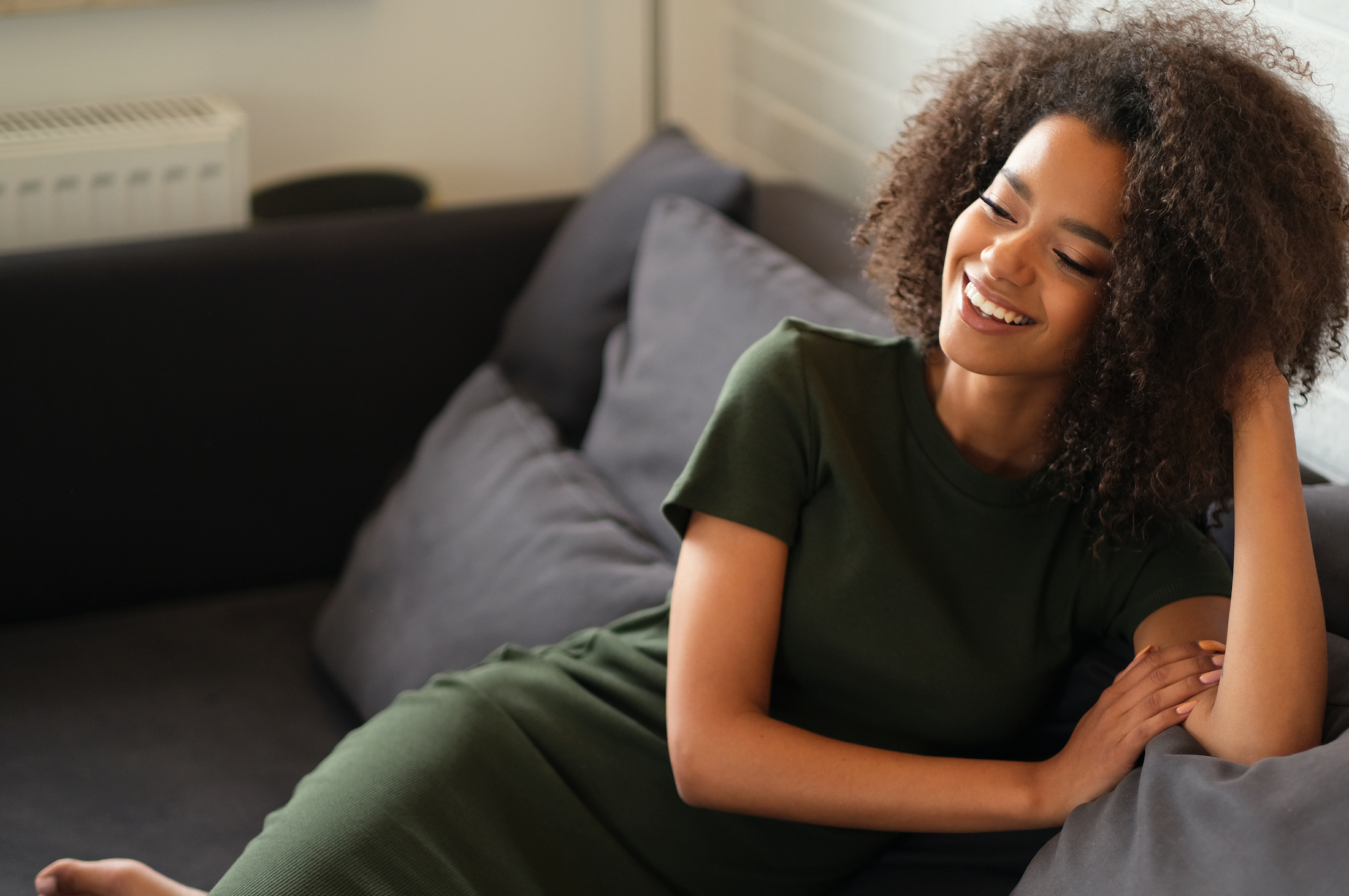 Happy woman sitting on a sofa