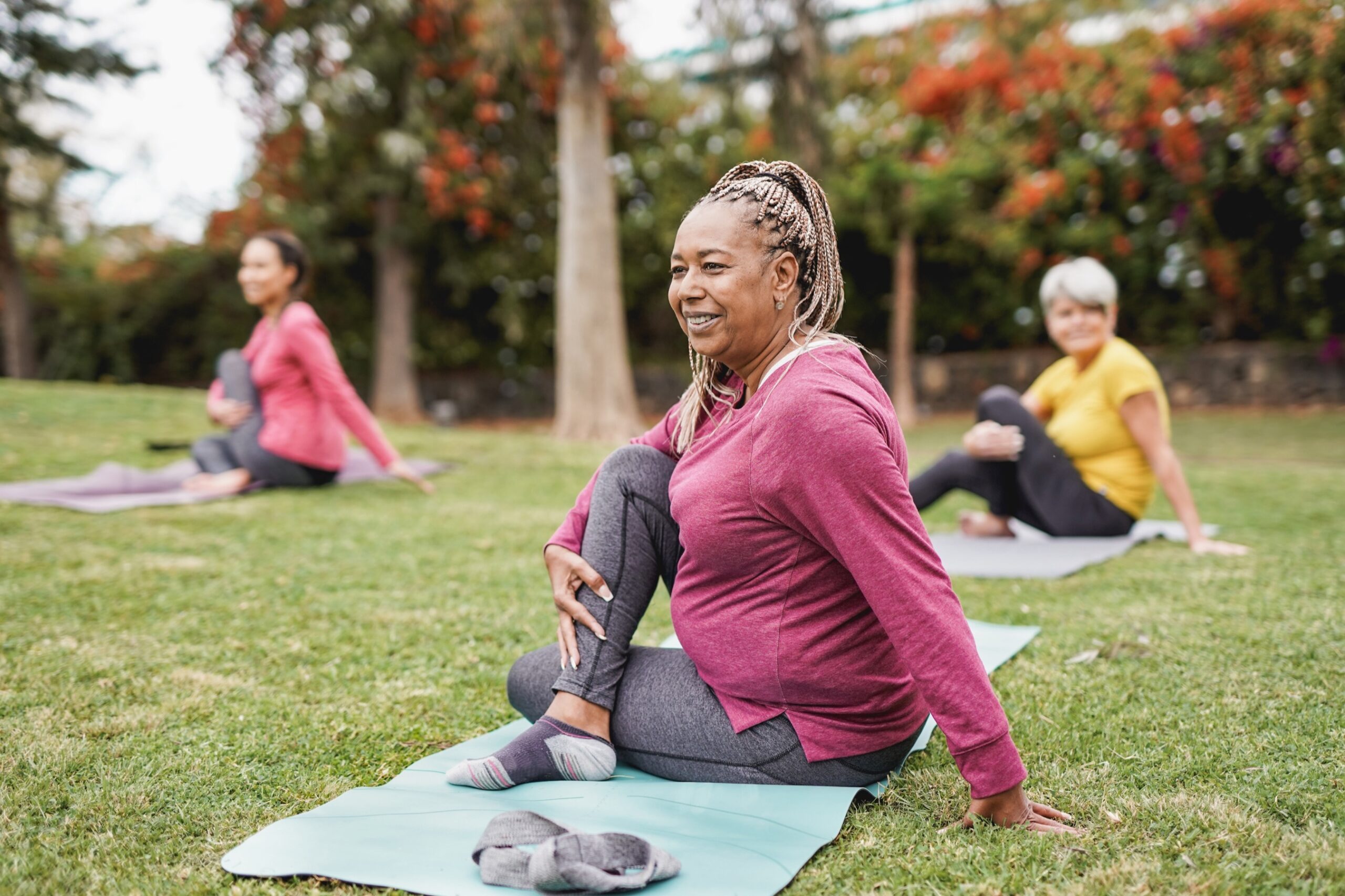 Older women practicing yoga outside